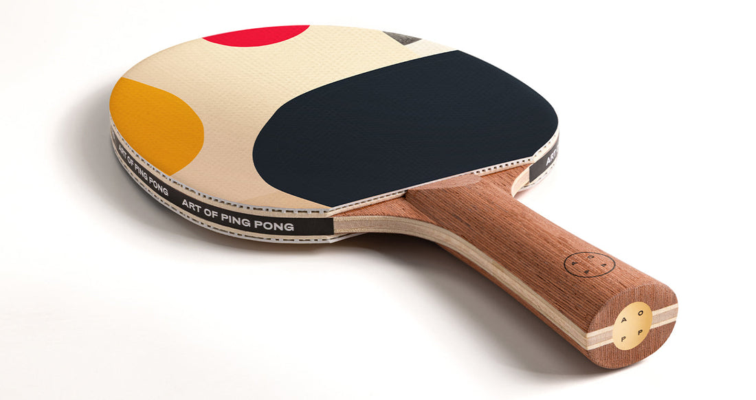 Ping Pong Paddle, with printed rubber and brass lens in handle base by Art of Ping Pong on white background