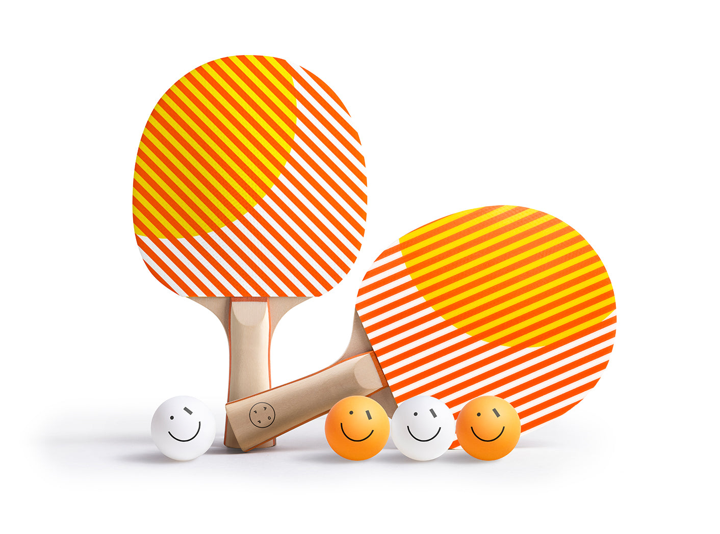 Two orange and white striped ping pong paddles with smiley face balls on a white background
