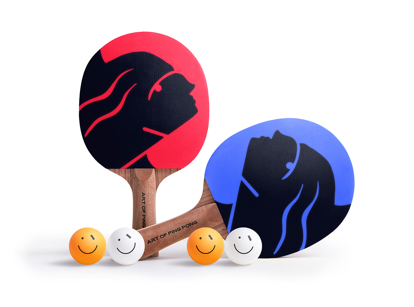 Two ping pong paddles with black and red or blue and black designs, accompanied by four small colorful balls on a white background.