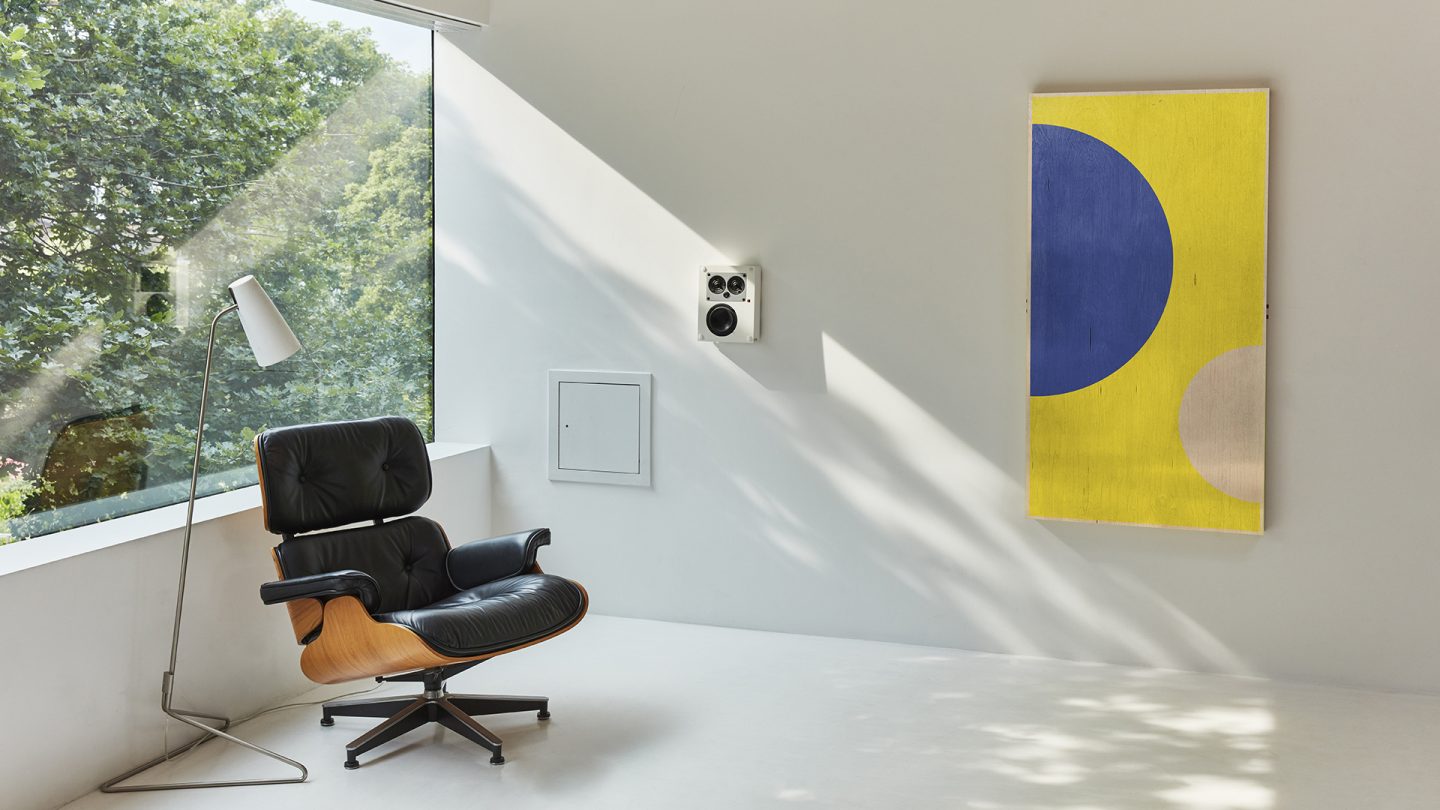 Half Moon ArtTable on white wall in studio with Eames Chair and designer light