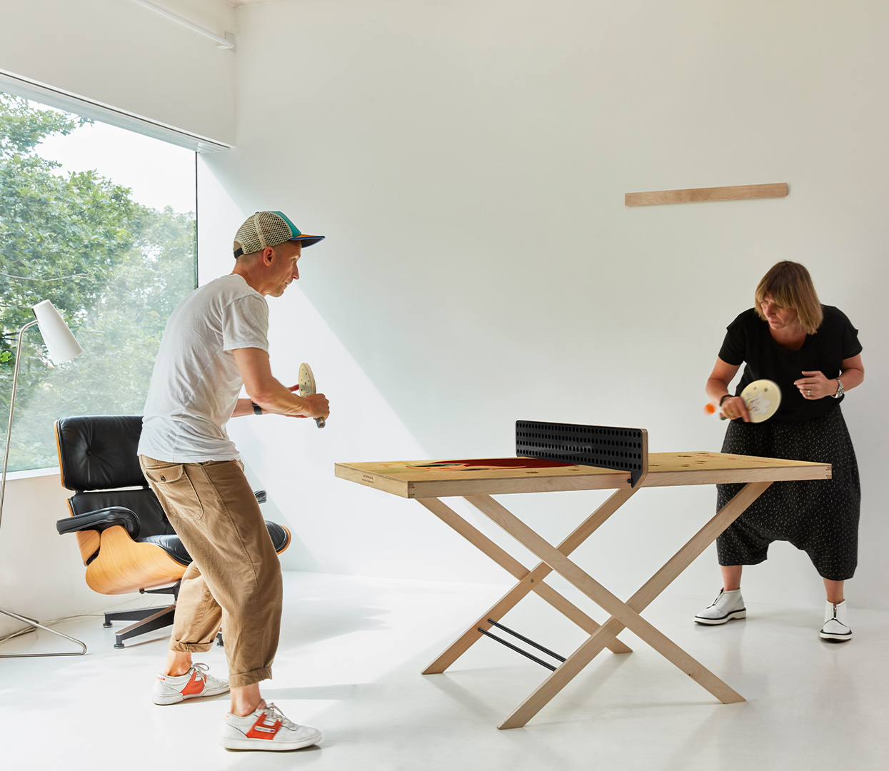 Javier Calleja x Art of Ping Pong ArtTable in white studio with Eames Chair